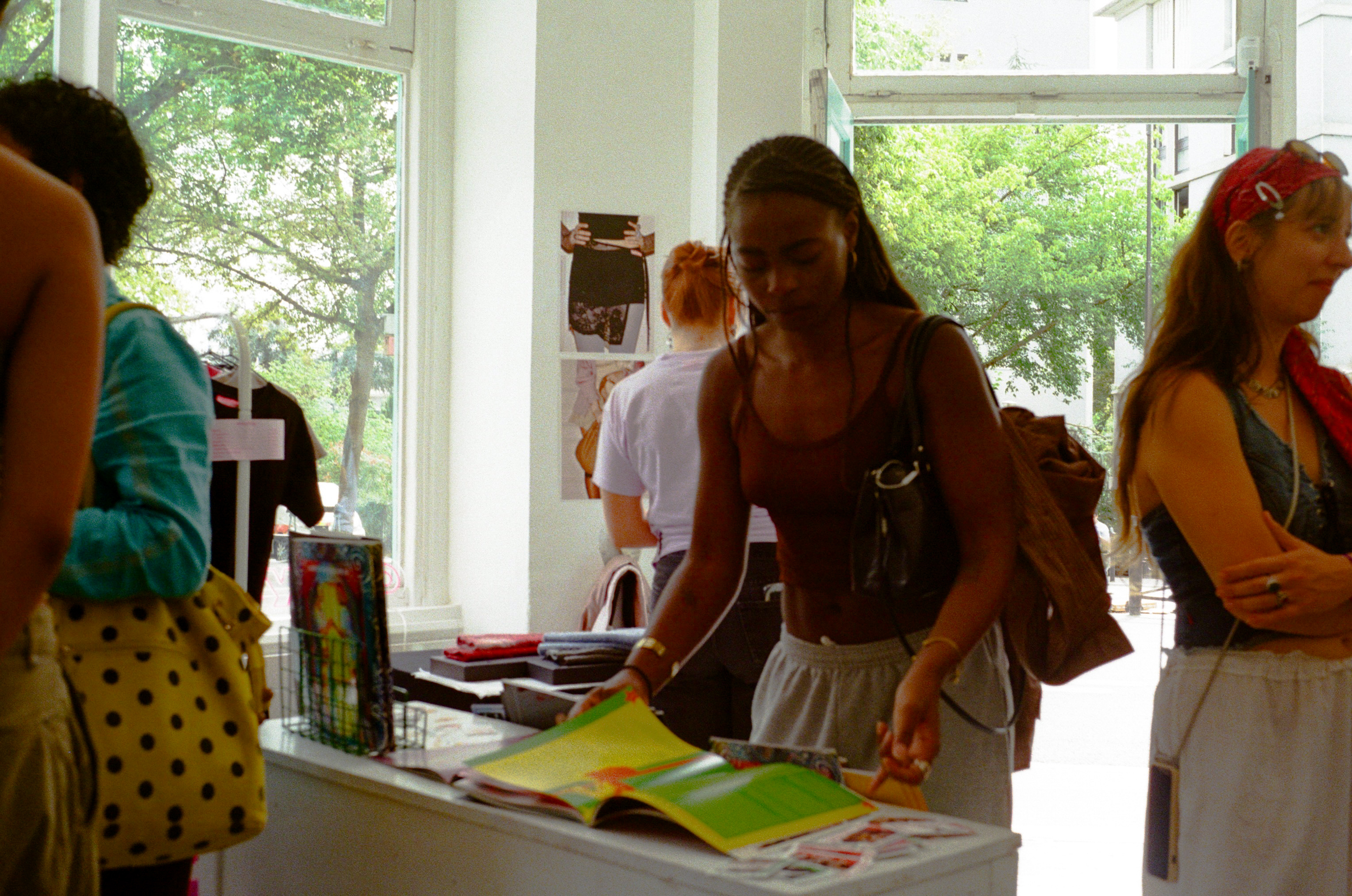 A visitor looking through a publication at the Floréal Belleville pop-up